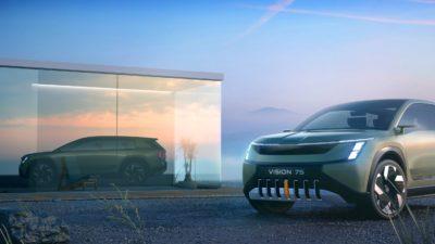 Elektro-Van Skoda Vision 7S in grün vor spiegelnder Glasfläche und blauem Himmel
